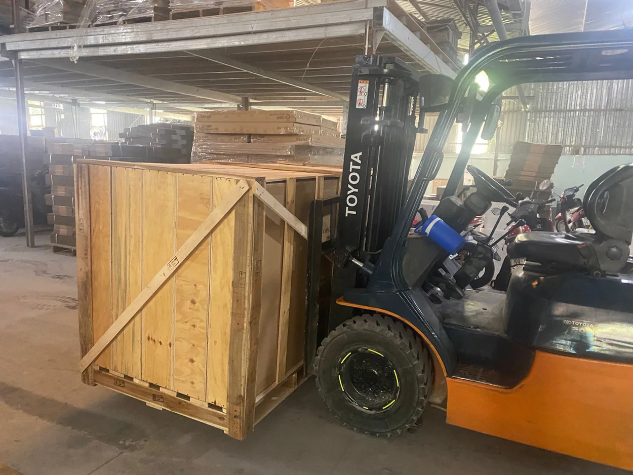 Forklift moving wooden furniture crate Forklift moving a wooden furniture crate for export loading