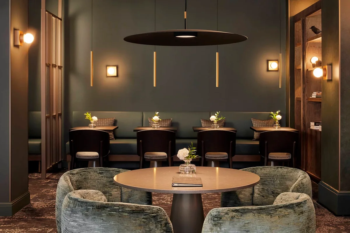 Hotel cafe upholstered armchairs beside dining tables