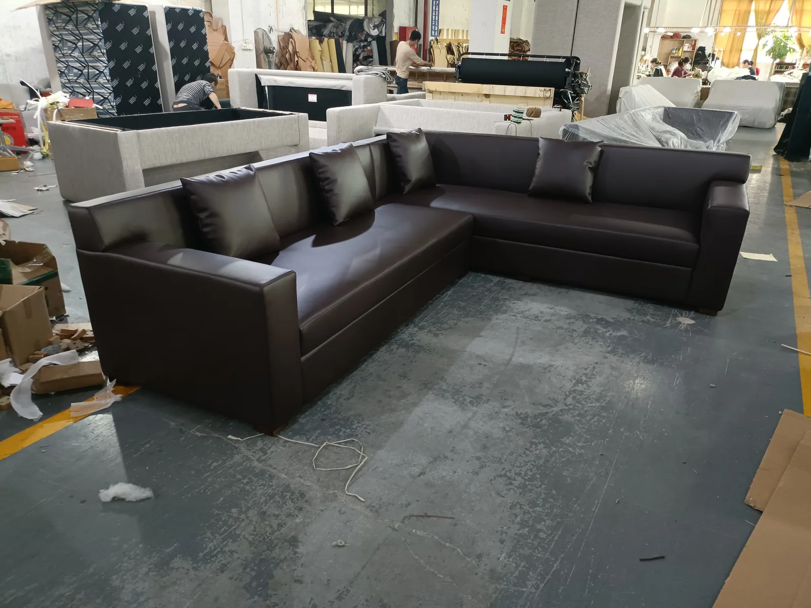 Dark brown leather-look sofa and matching seating displayed as a coordinated set