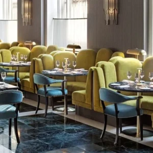 Green banquette booth seating in a restaurant dining space