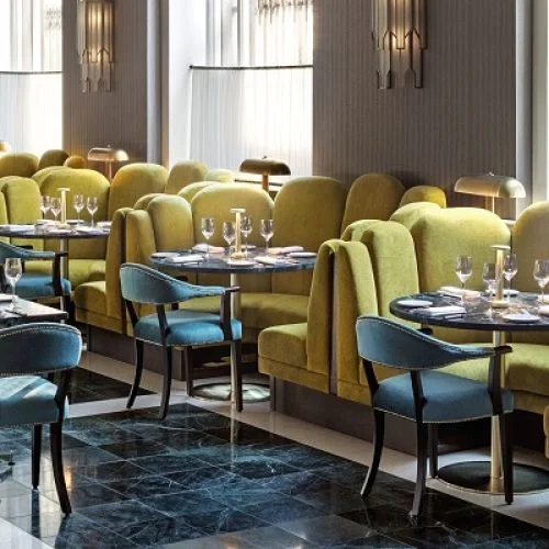 Green banquette booth seating in a restaurant dining space