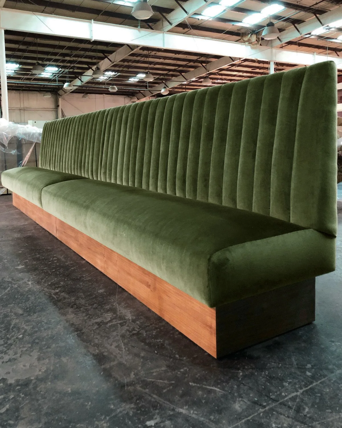 Straight wall banquette seating with upholstered back for restaurant layout