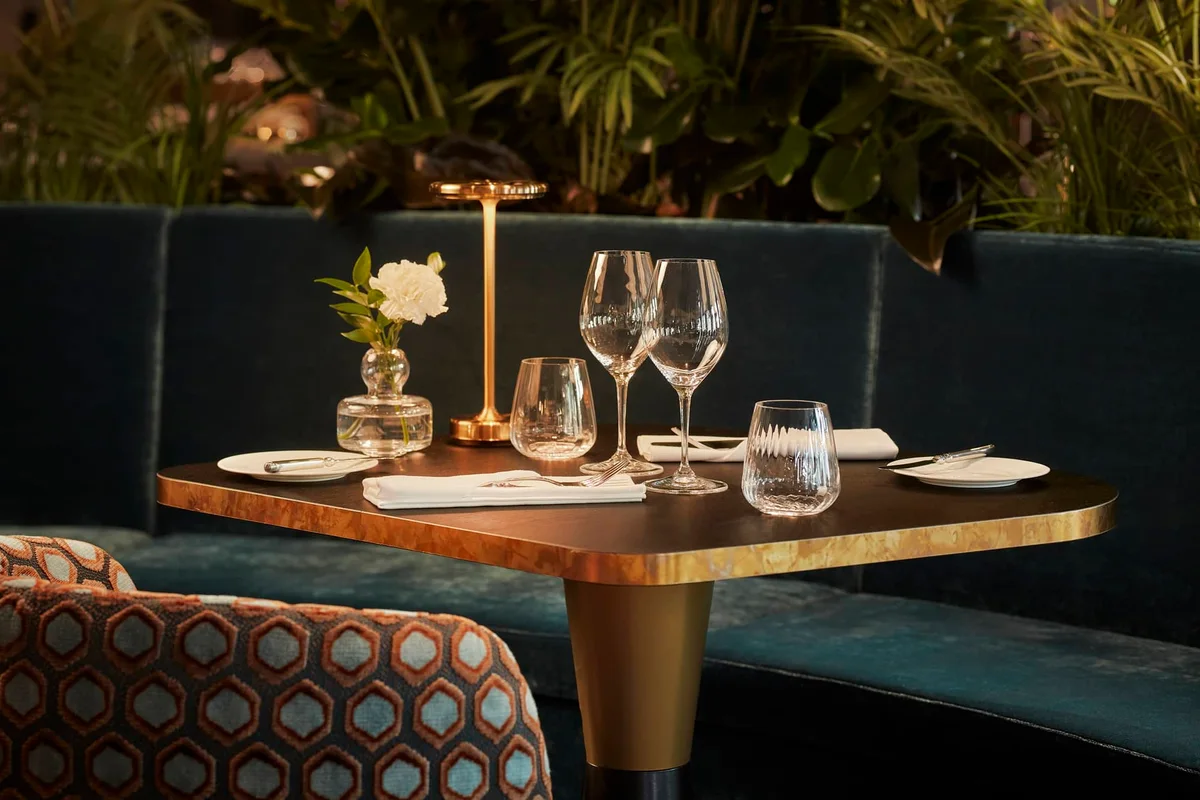 Upholstered dining chairs arranged around restaurant tables