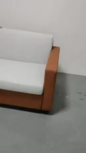 Airbnb sofa bed in closed sofa mode prepared for a short-term rental room