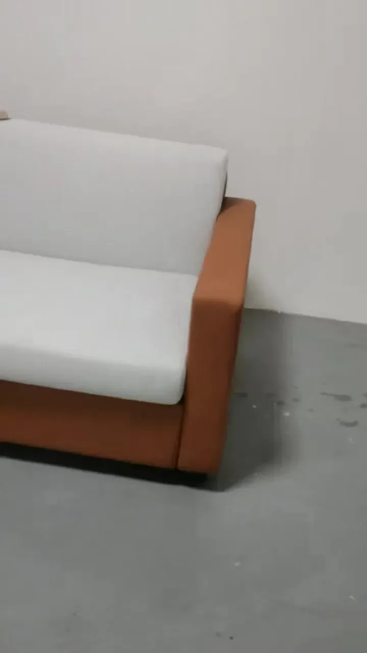 Airbnb sofa bed in closed sofa mode prepared for a short-term rental room