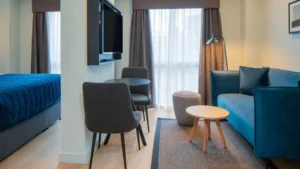Pull-out sleeper sofa for small apartments in a compact serviced apartment room scene
