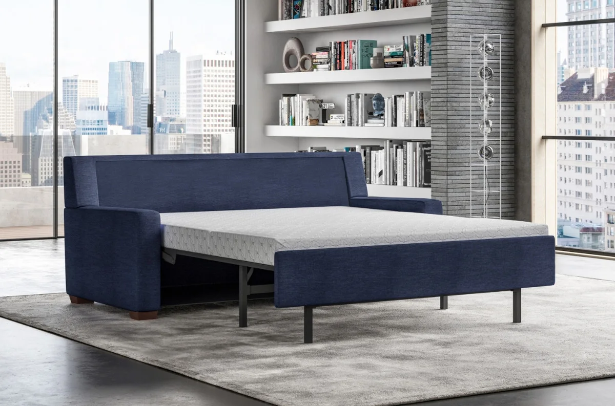 Pull-out sleeper sofa opened as a bed in a hotel apartment style room