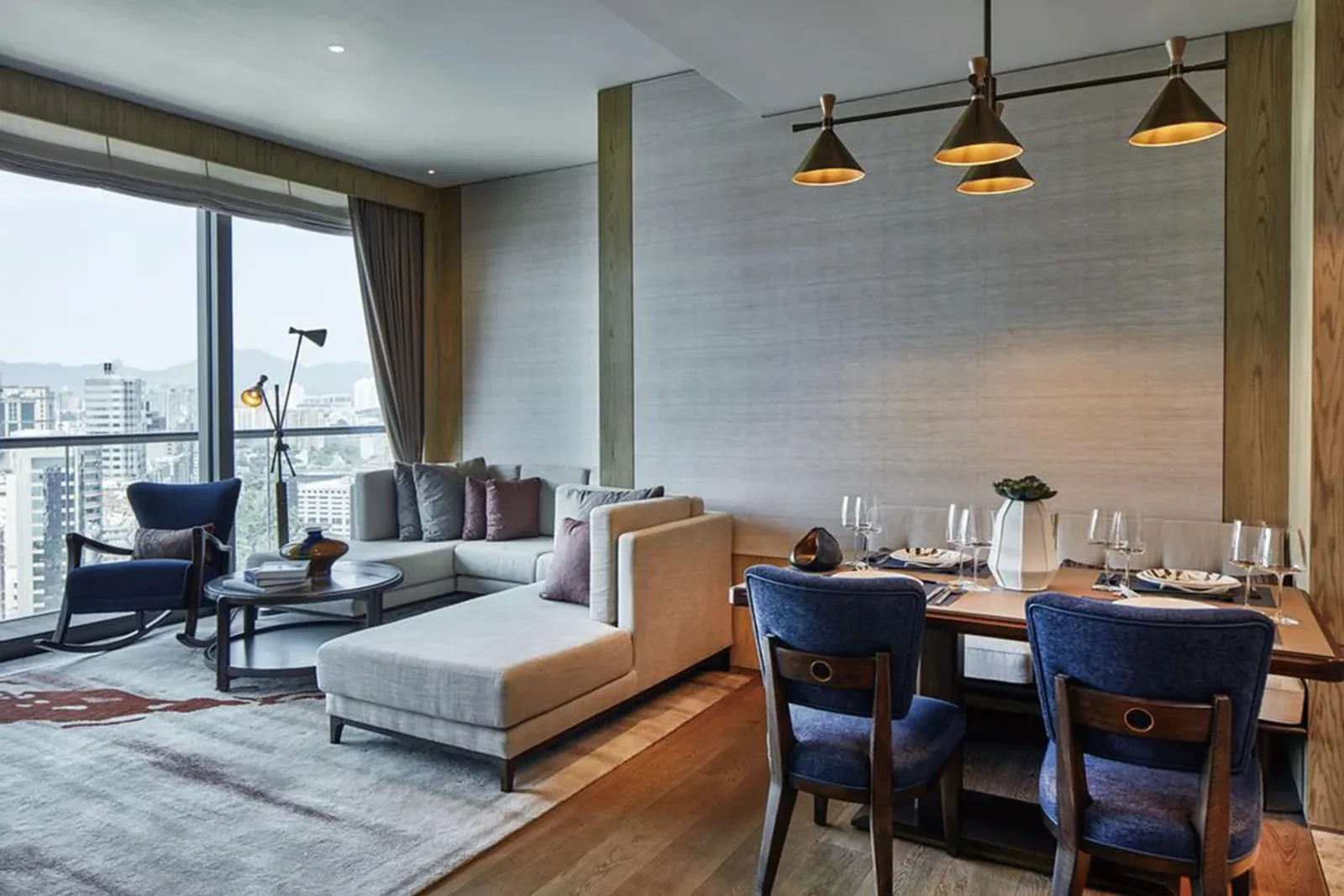 Hotel suite living area with sofa, lounge chair and tables