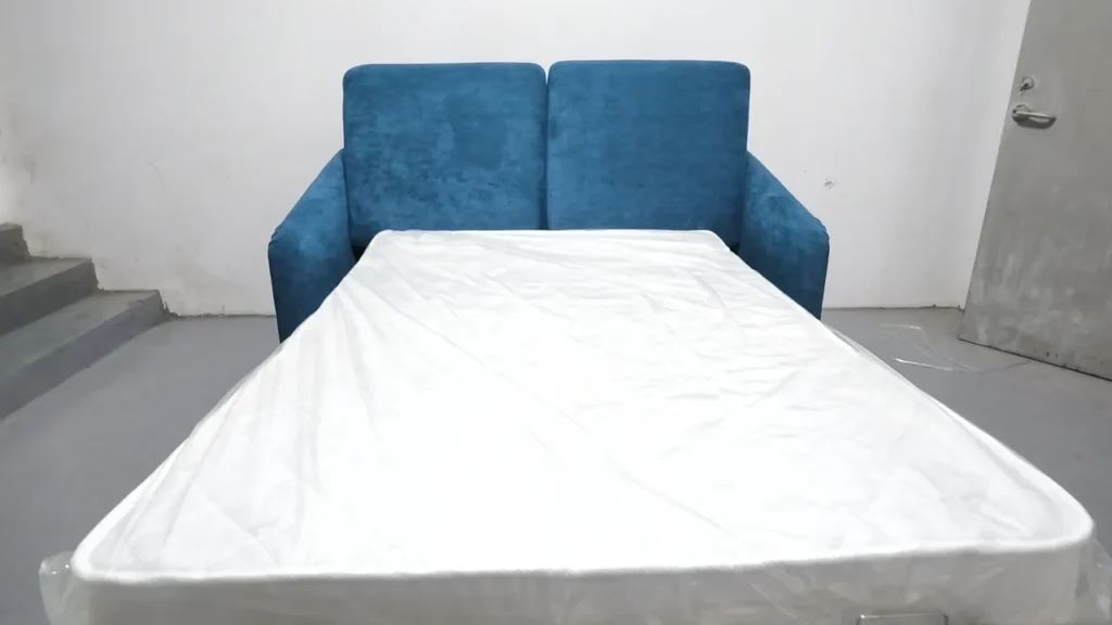 Poster frame showing a HUAXUAN Furniture sofa bed function test inside the factory.