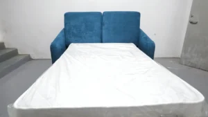 Poster frame showing a HUAXUAN Furniture sofa bed function test inside the factory.
