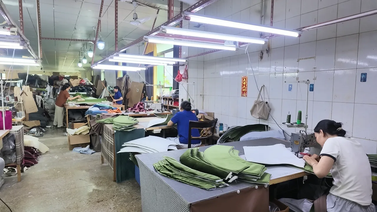 Upholstery materials being cut and sewn in the HUAXUAN furniture workshop