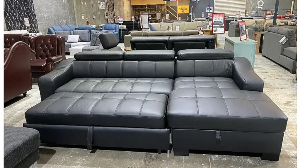 Black leather sofa bed in commercial showroom scene