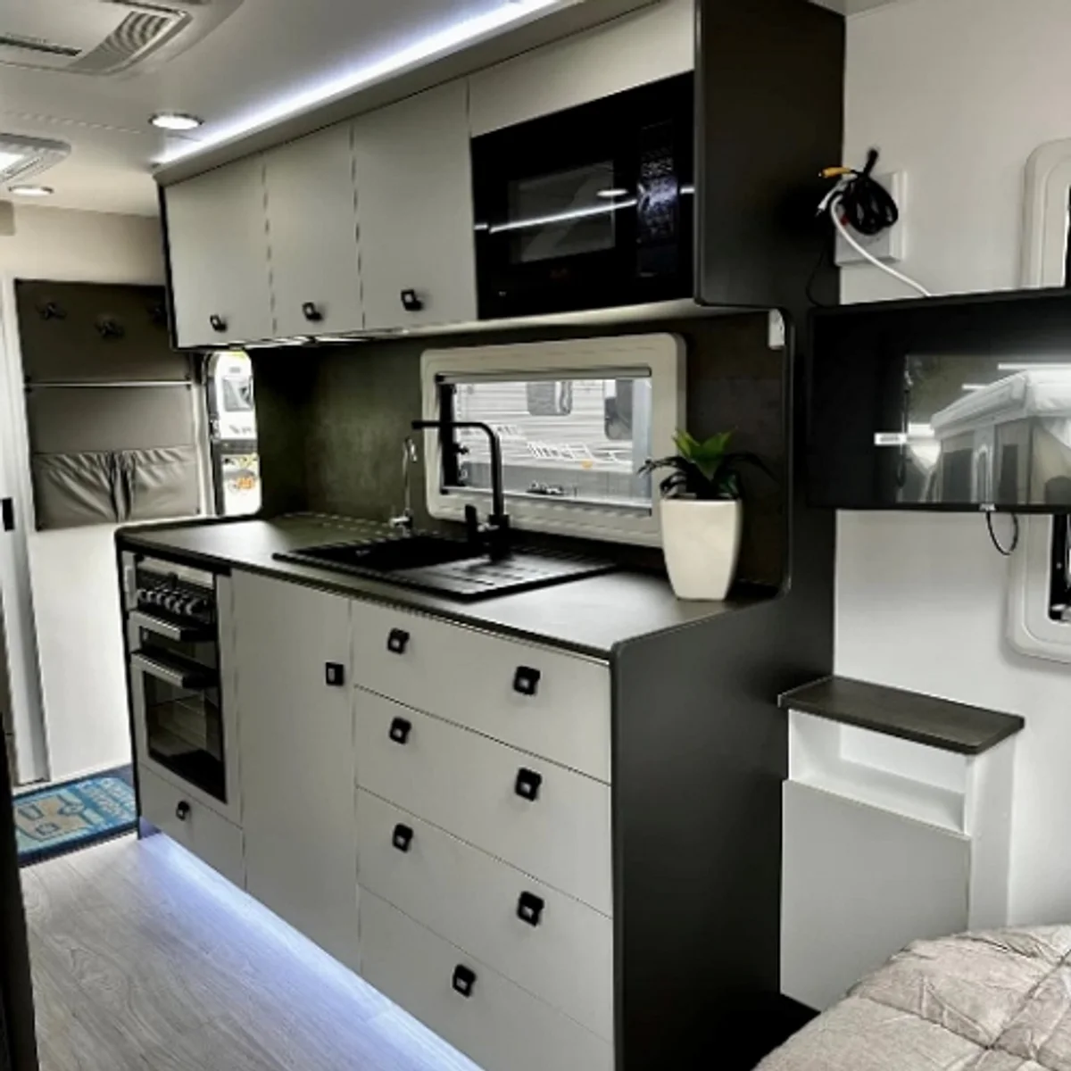 Compact RV interior furniture layout with built-in seating area