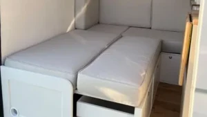 RV sofa bed opened inside a compact camper interior