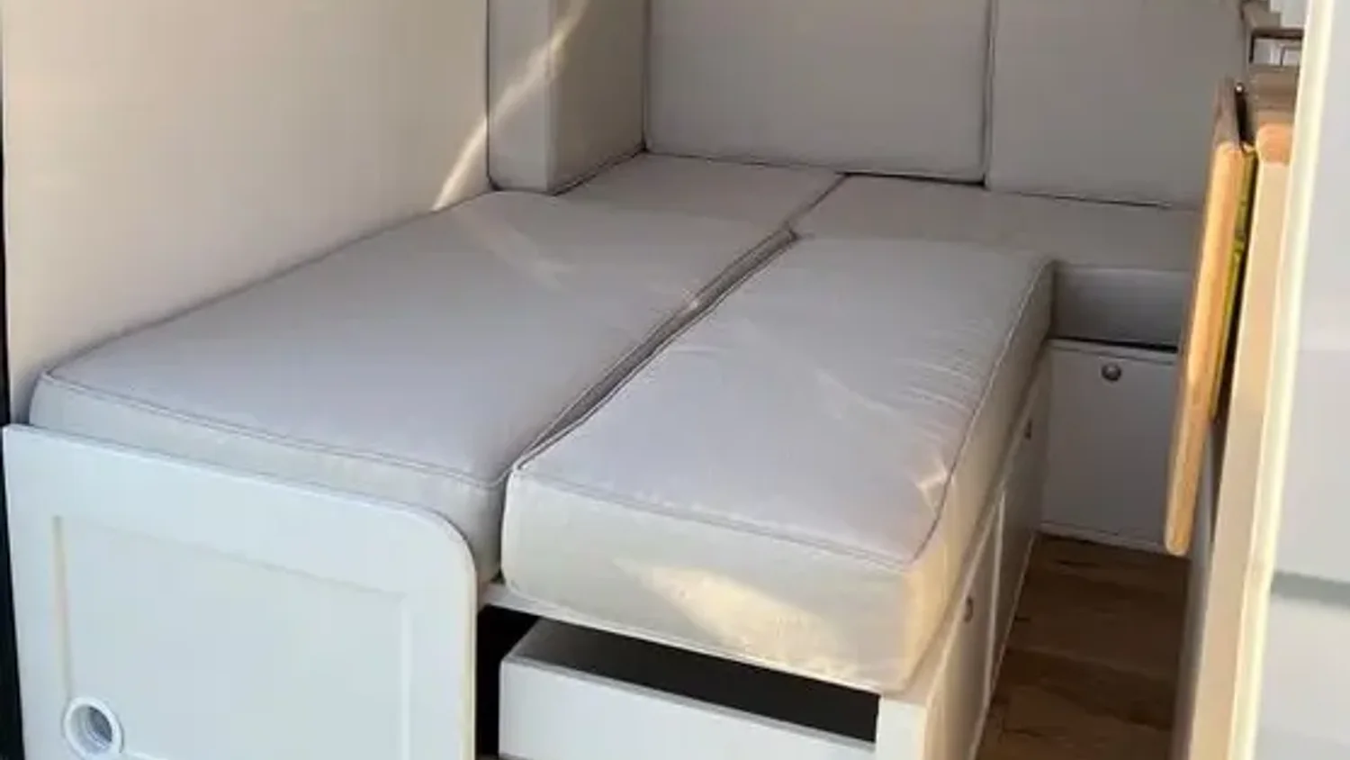 RV sofa bed opened inside a compact camper interior