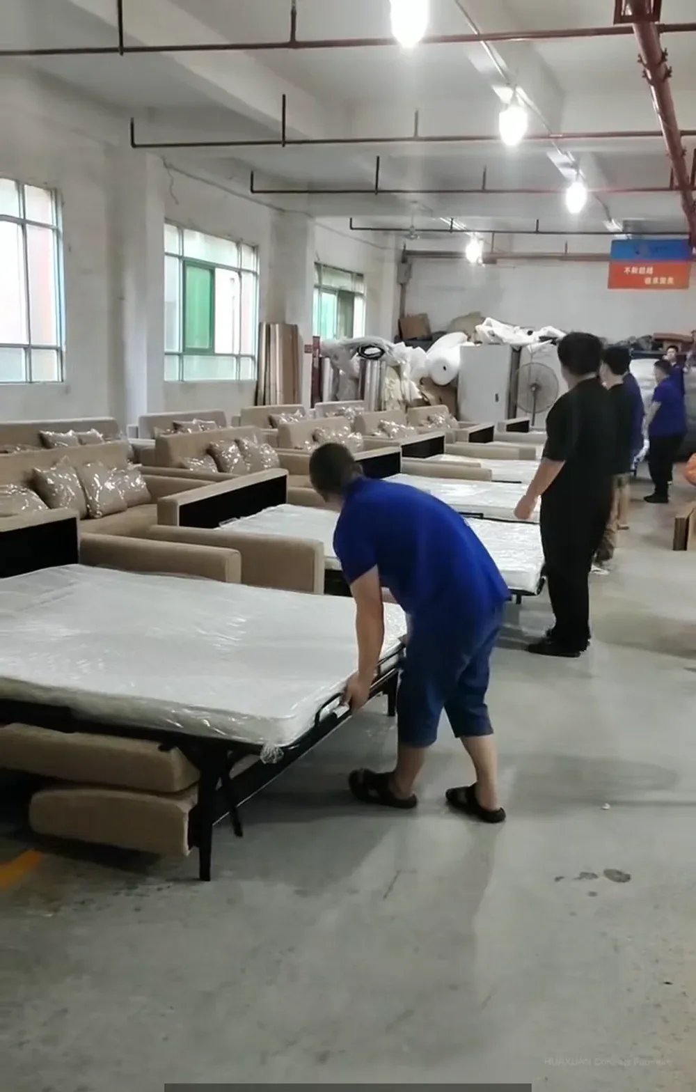 Sofa bed mechanism function check Inspector operating a pull-out sofa bed during bed-mode inspection