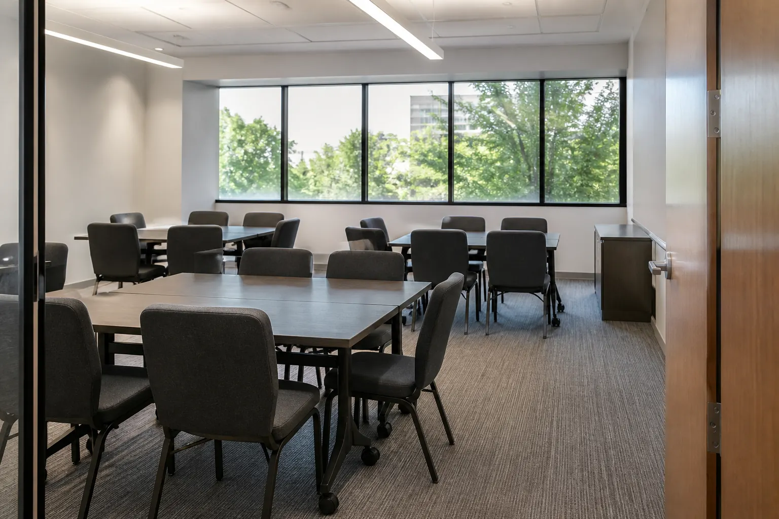 Compact meeting chairs arranged efficiently around modular training tables