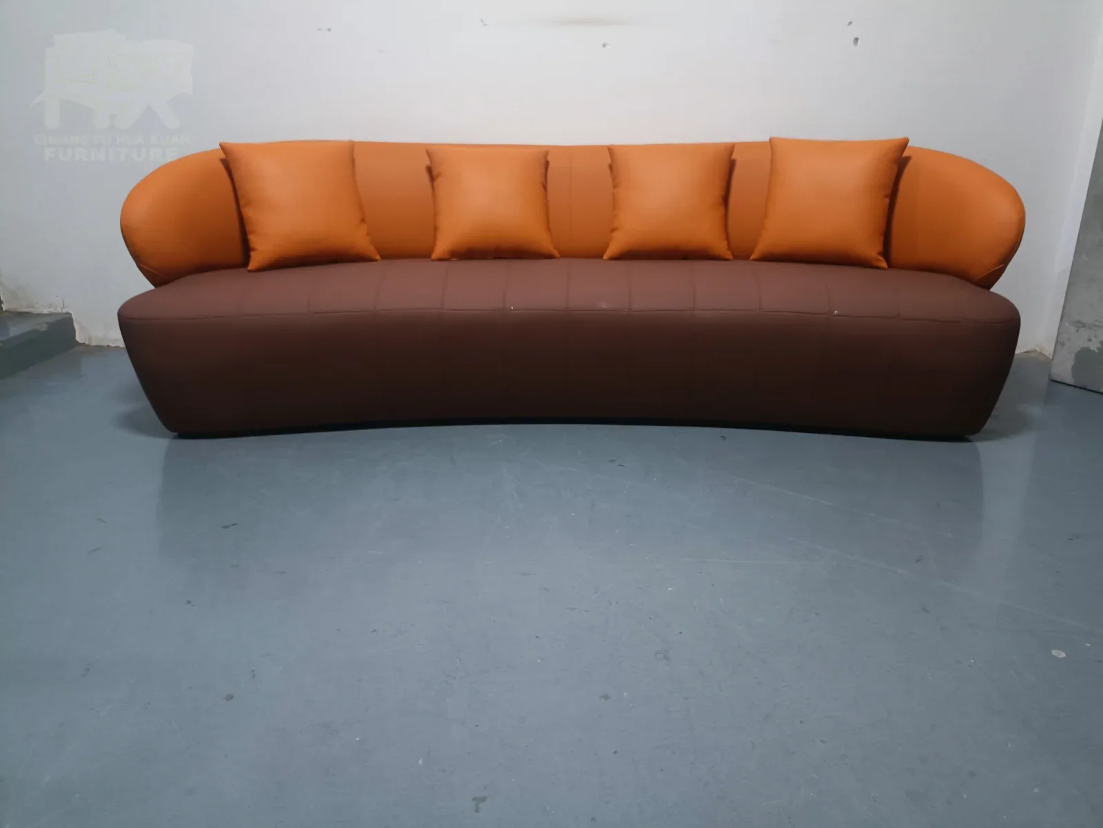 Custom curved upholstered sofa with complex seams and geometry
