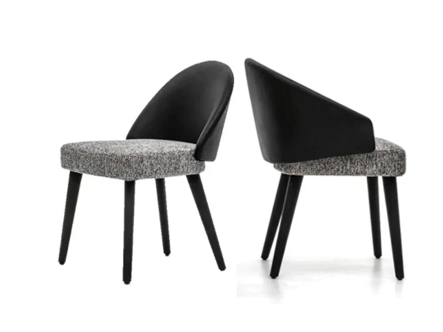 Compact armless upholstered dining chair for a round table