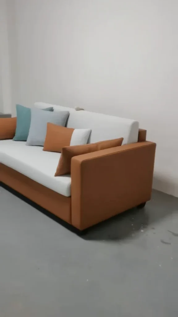 Brown and ivory hotel sofa bed in its closed seating position