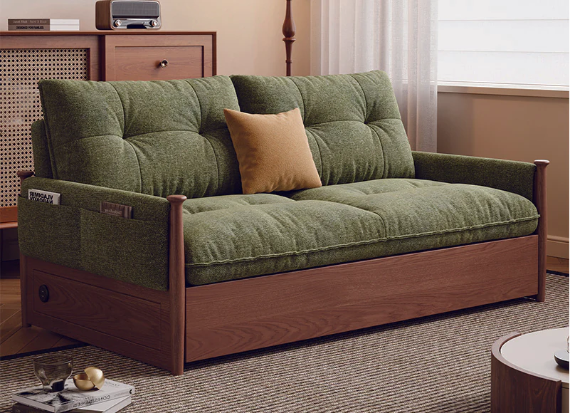 Green tufted pull-out sleeper sofa with exposed painted-oak frame in sofa mode