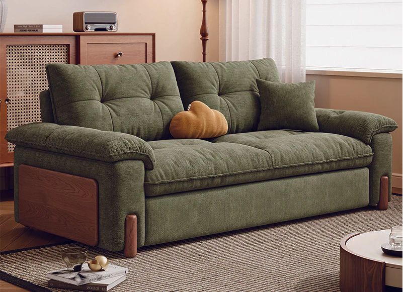 Moss green pull-out sofa bed with padded arms and painted-oak side panels