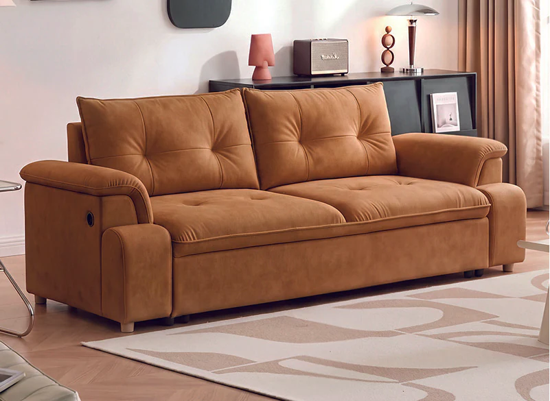 Caramel pull-out sleeper sofa with compact padded arms and button-detailed back