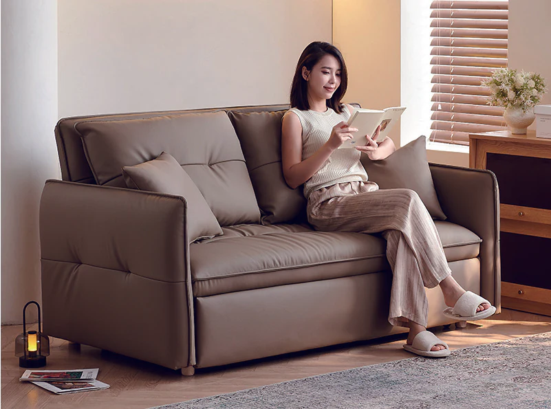 Brown manual pull-out sofa bed with slim angled arms and tufted cushions