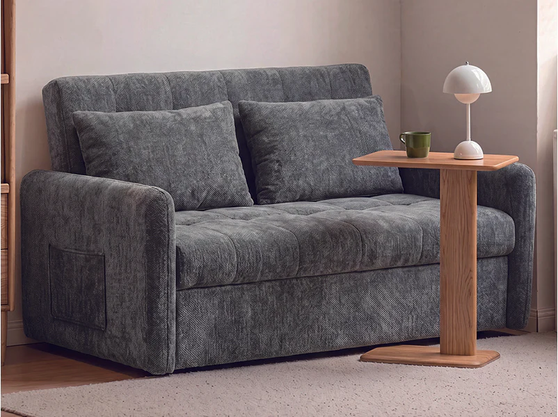 Blue-green compact pull-out sofa bed with boxed back cushions and narrow arms