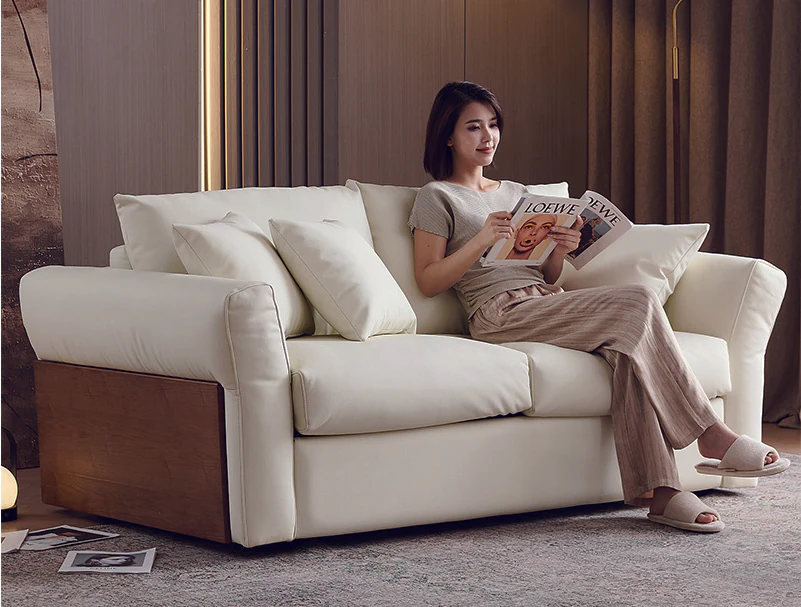 Ivory fold-out sofa bed with painted solid-wood outer arm panels
