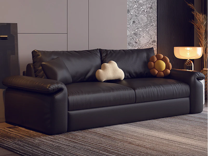 Black soft-arm fold-out sleeper sofa with loose back and accent cushions