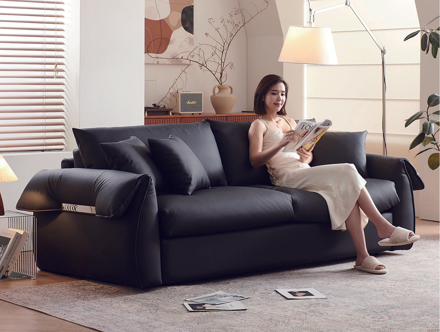 Charcoal pillow-arm fold-out sofa bed with metallic arm accent