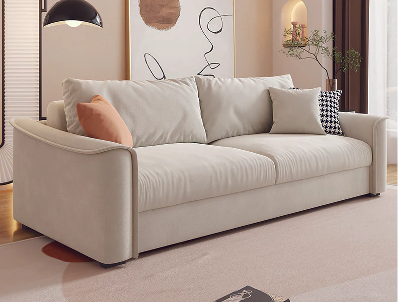 Wide ivory curved-arm mattress sleeper sofa with loose cushions