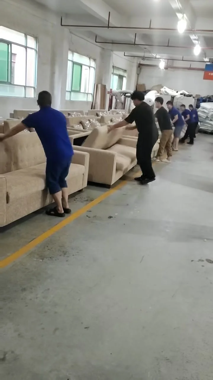 Workers closing modern pull-out sofa beds after a workshop function check