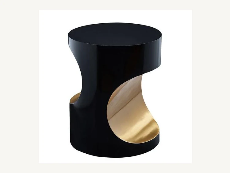 Ribbon-cutout drum side table with contrasting gold-tone interior