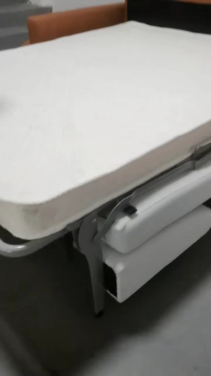 Close view of a pull-out sofa bed mattress, metal frame and support leg