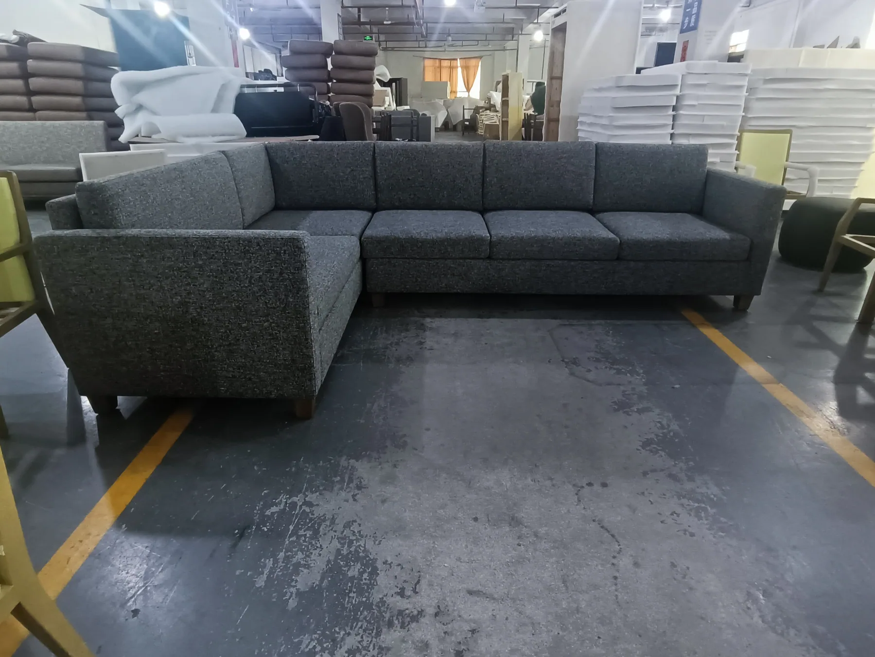 L shaped sectional sofa in dark grey woven upholstery
