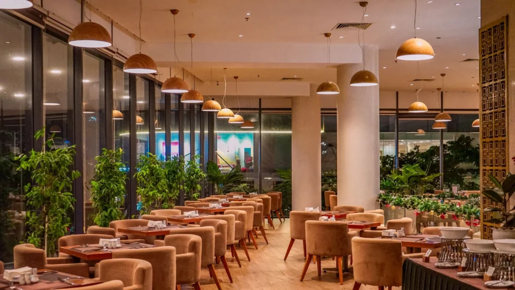 Application reference: upholstered dining armchairs arranged at wooden tables in a contemporary restaurant