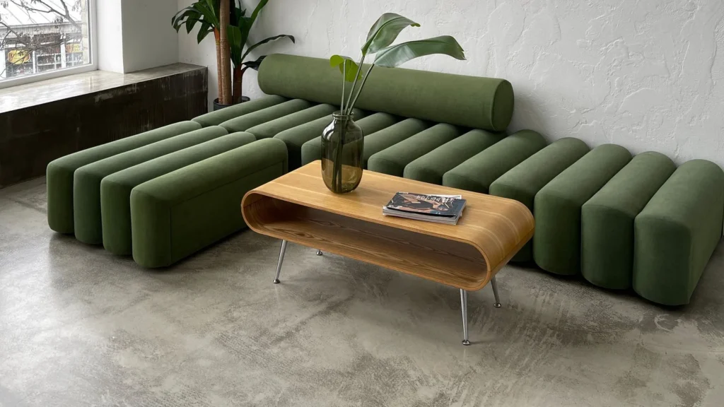 Application reference: a green sofa and wooden table beside a large window