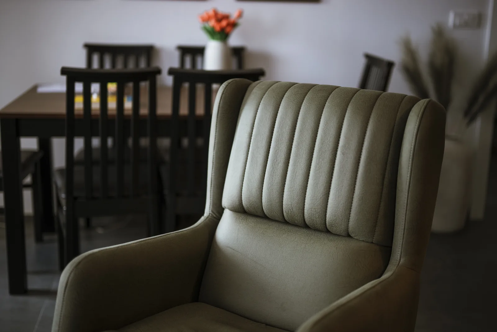 Rounded upholstered chair in front of a dining table
