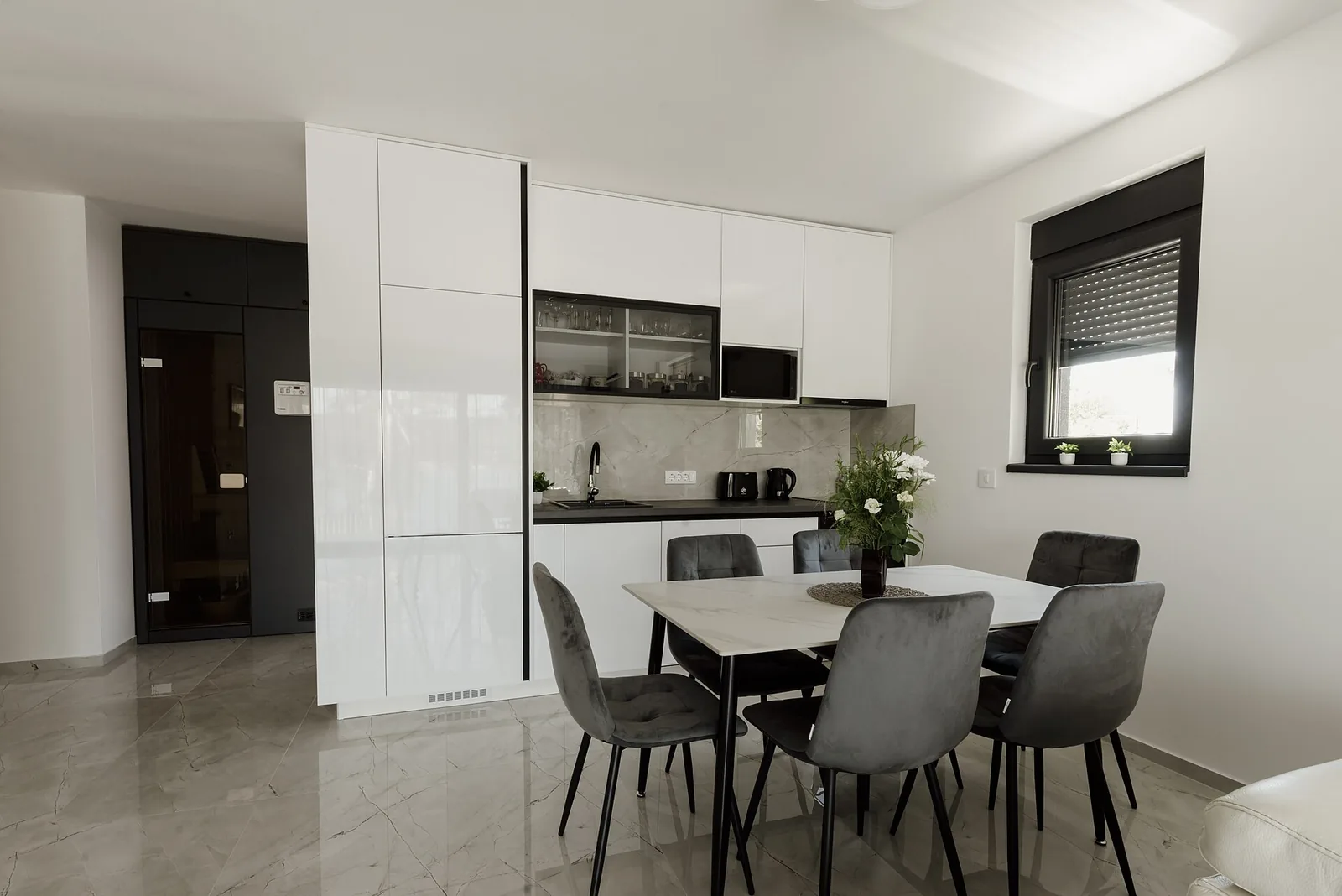 Gray upholstered dining chairs repeated around a table