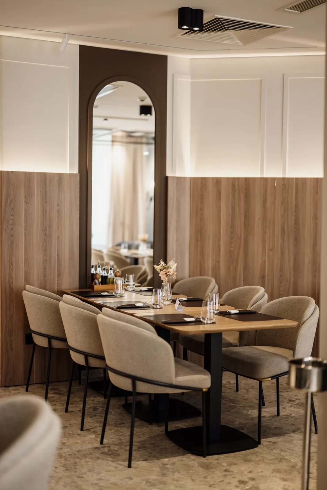 Upholstered dining chairs in a softly lit restaurant