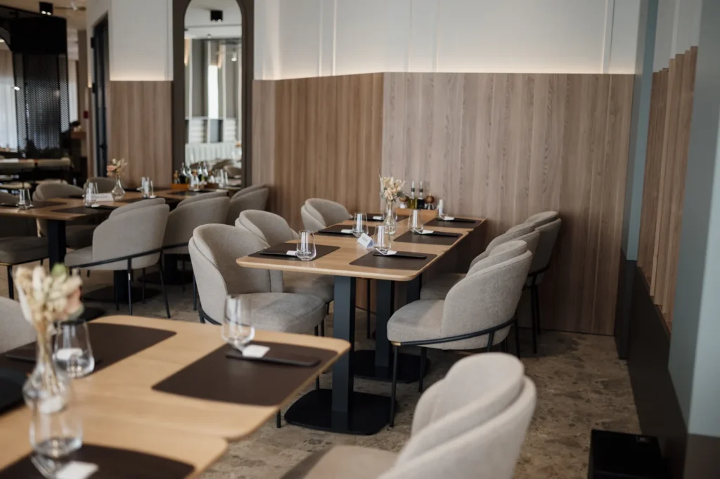 Upholstered dining chairs at tables in a modern restaurant