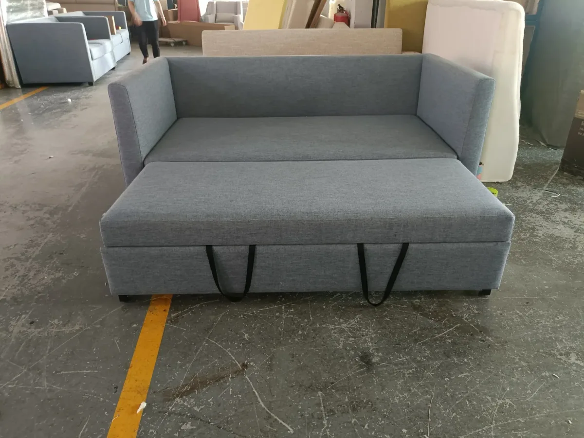 Grey fabric sofa bed photographed at an angle with the pull-out base extended