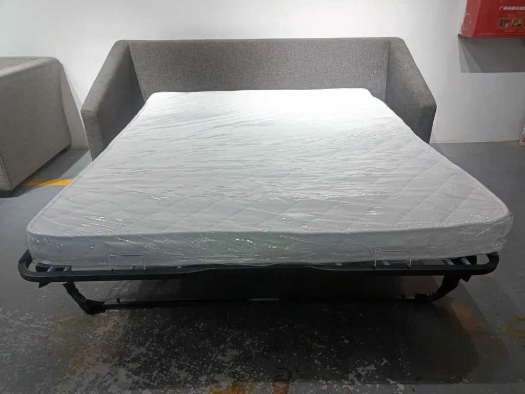 Grey pull-out sofa bed opened in the HUAXUAN workshop
