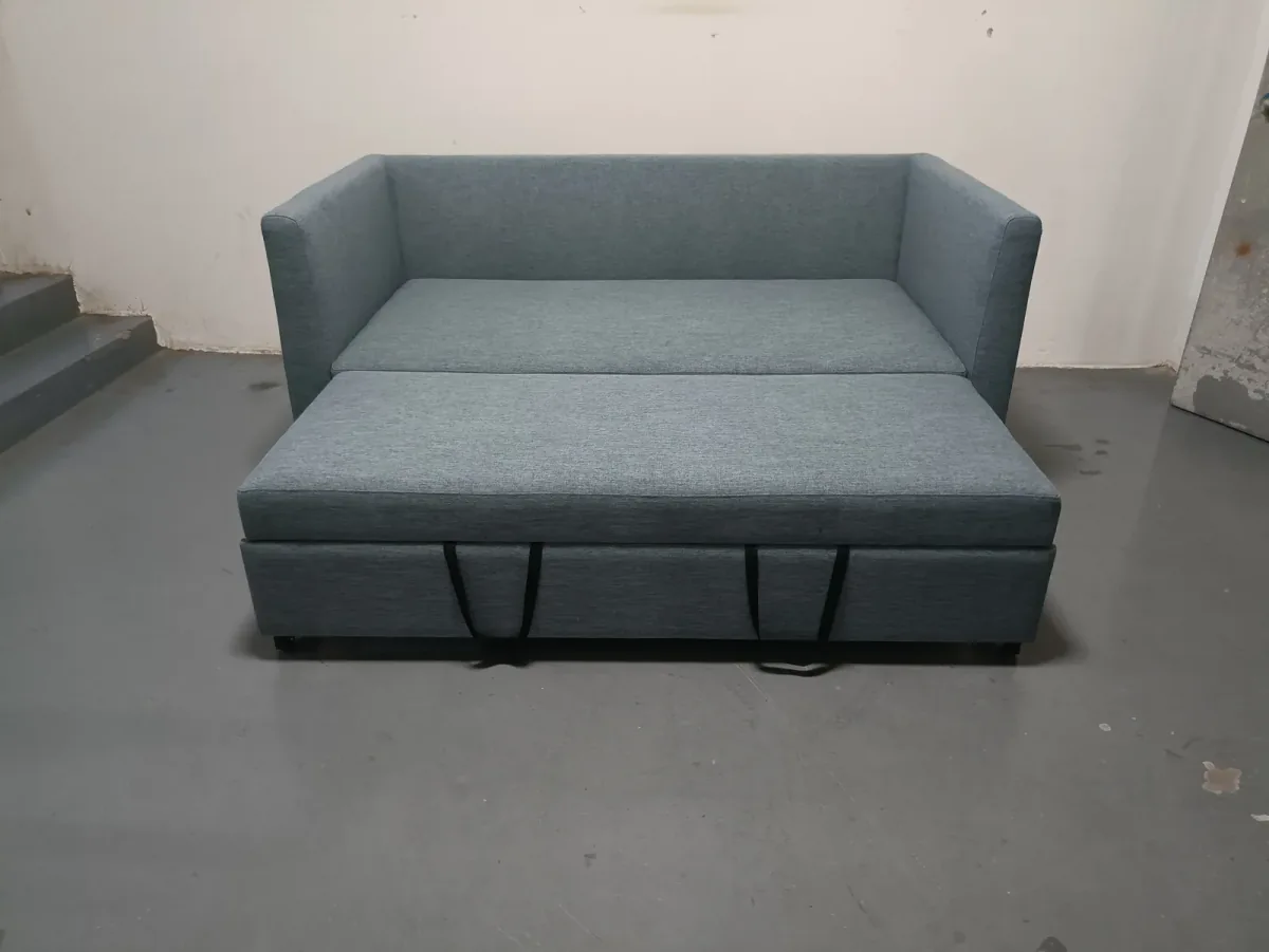 Grey sofa bed with its lower pull-out base partly extended