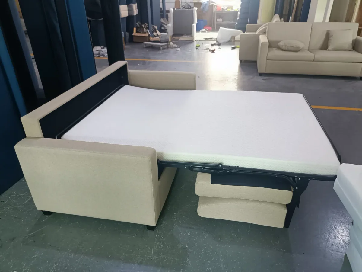 White sofa bed with its pull-out support platform extended in the workshop